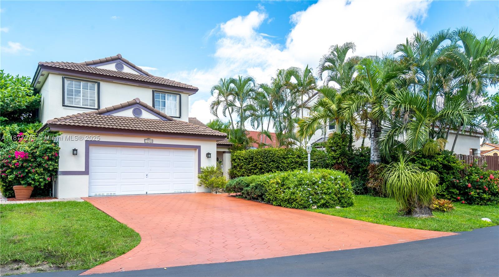 A two-story house with a white garage, a red paved driveway, and palm trees — 15905 SW 83rd Ter, Miami FL 33193, MIAMI, FL
