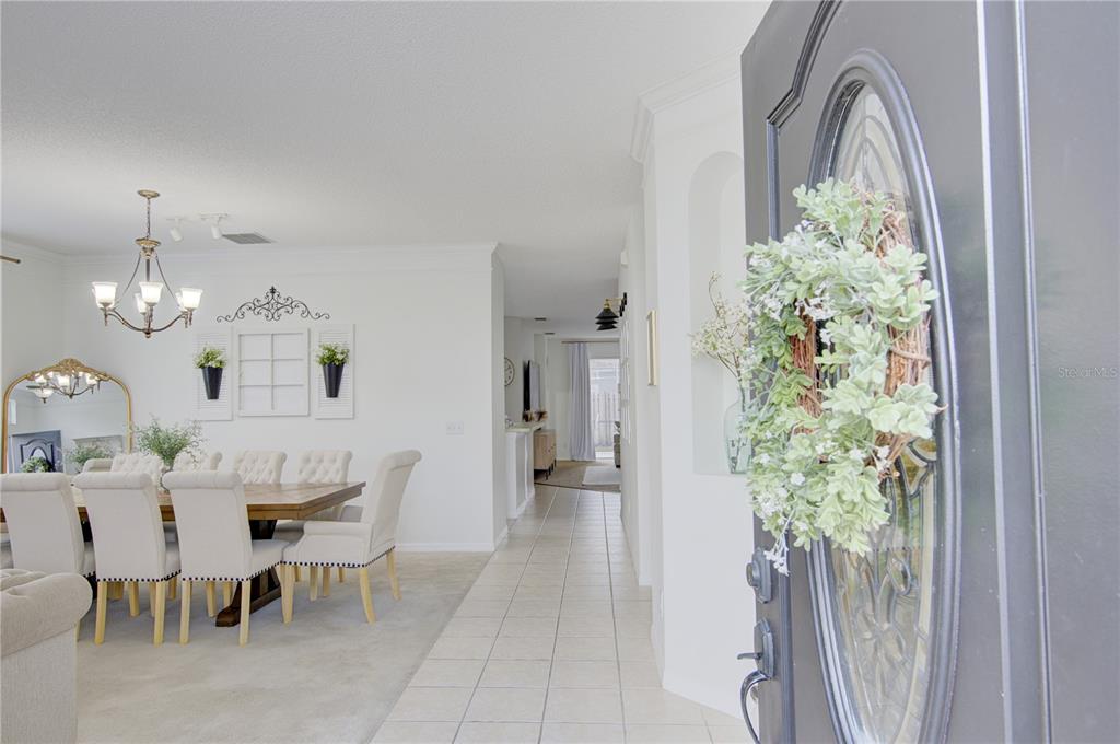 A view from an open front door into a dining room with tile flooring — 963 CHERRY VALLEY WAY, ORLANDO, FL