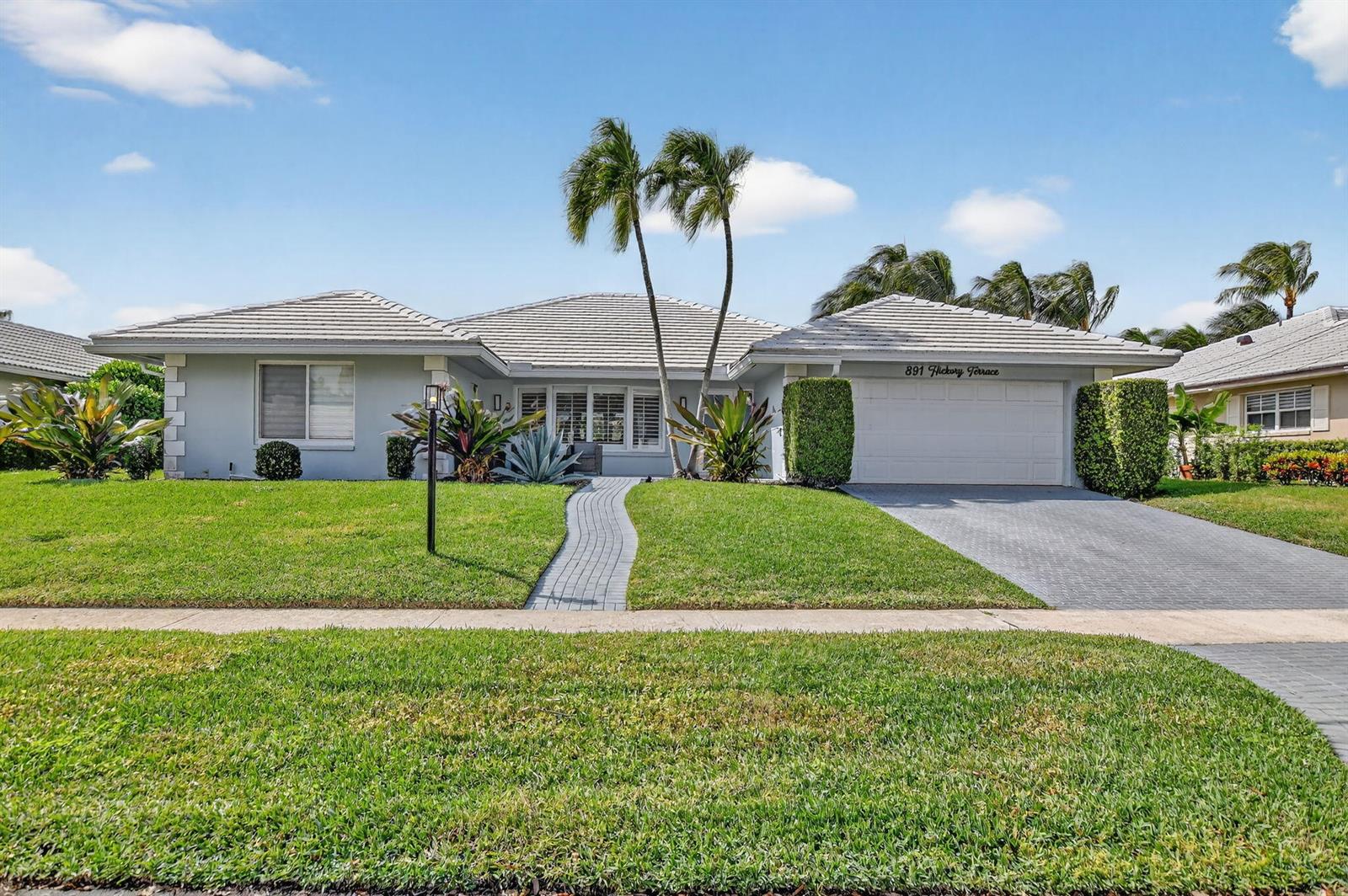 A single-story house with a gray tiled roof, palm trees, and a paved driveway — 891 Hickory Terrace, Boca Raton FL 33486, BOCA RATON, FL