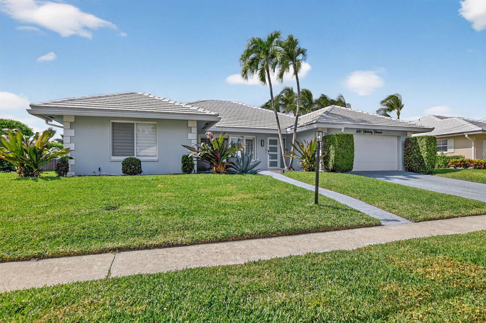 A single-story house with a light gray exterior, a tiled roof, and a paved walkway — 891 Hickory Terrace, Boca Raton FL 33486, BOCA RATON, FL