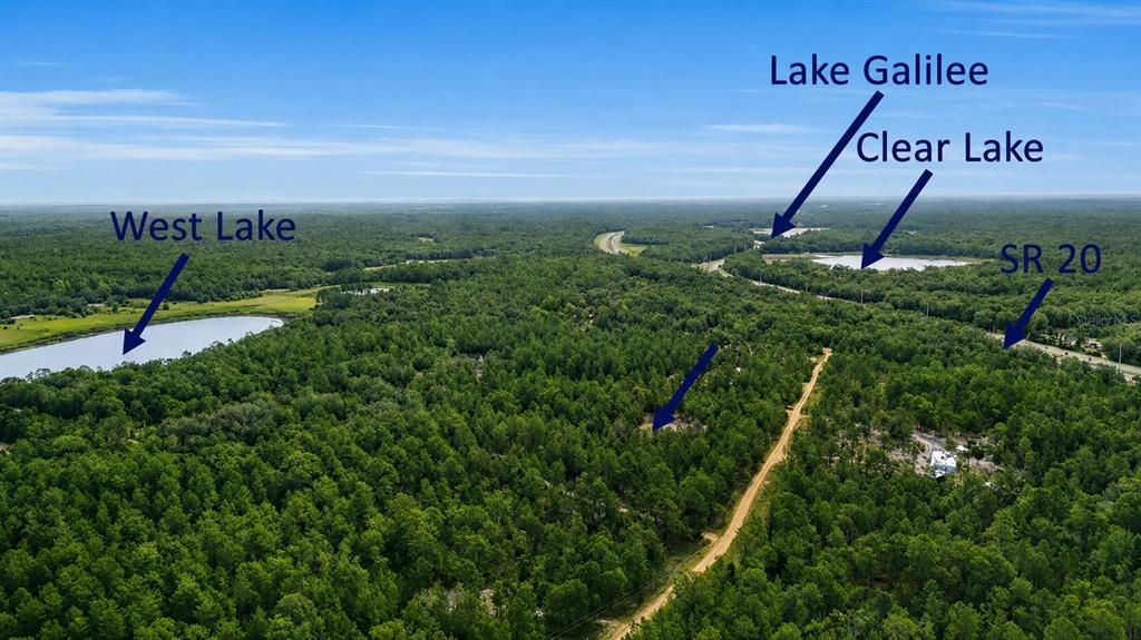 An aerial view shows a wooded landscape with three lakes and a road — 00 UNASSIGNED LOCATION, HAWTHORNE, FL