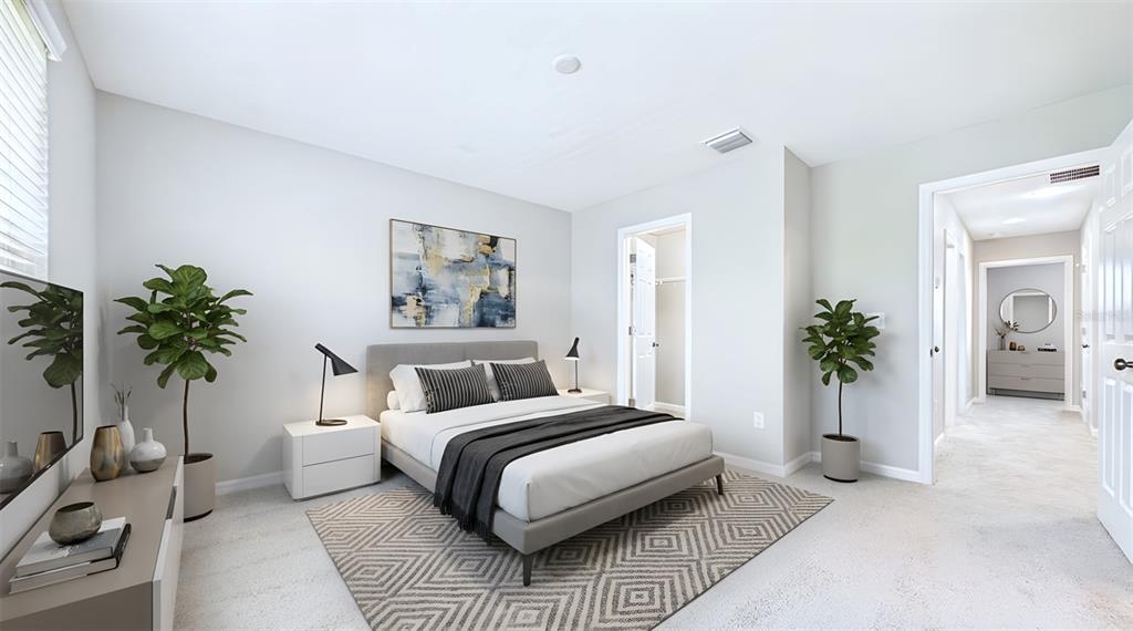 A modern bedroom features a gray bed, two potted plants, and a geometric area rug — 7214 GRAND ELM DRIVE, RIVERVIEW, FL