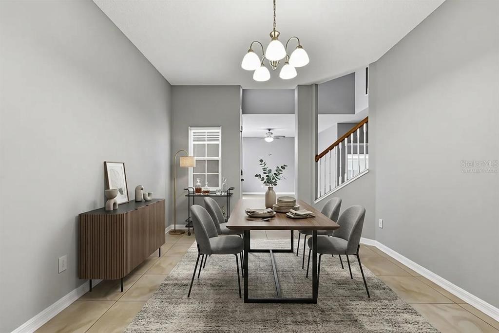 A dining room with gray walls, tile flooring, a wooden table, and a chandelier — 4317 HICKORY STONE CIRCLE, ORLANDO, FL