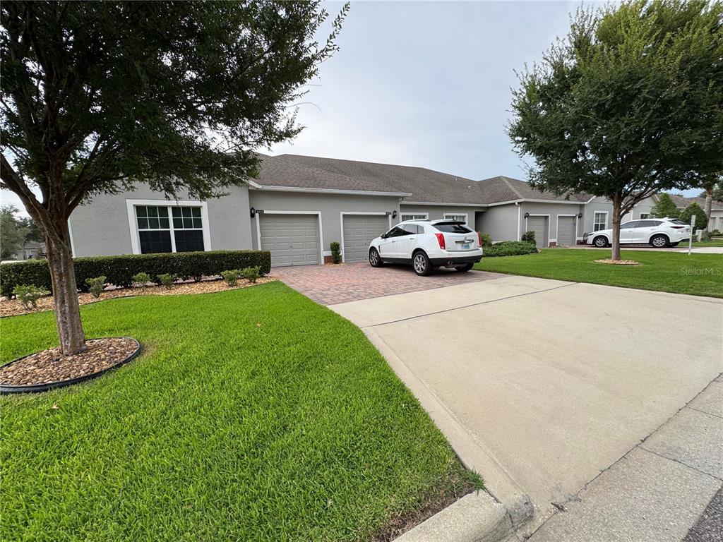A gray single-story house with two garage doors and a paved driveway — 3641 SOLANA CIRCLE UNIT B, CLERMONT, FL
