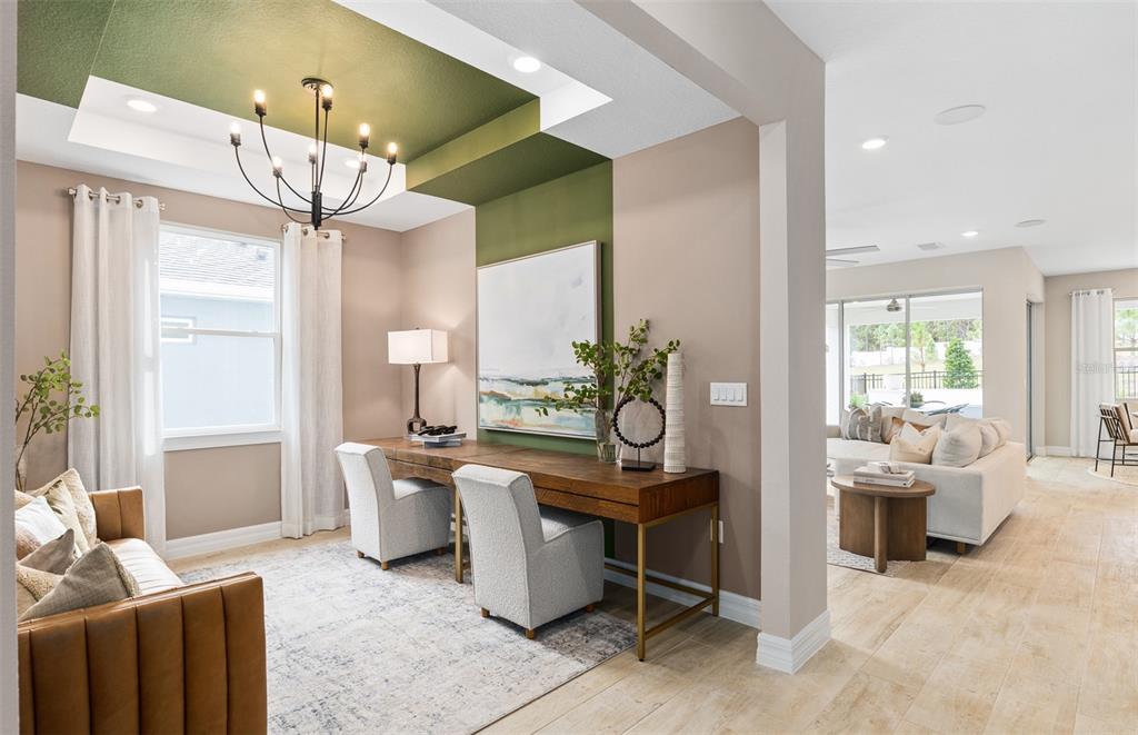 A home office features a green tray ceiling, a long wooden desk, and two chairs — 5042 DANCY LANE, ST CLOUD, FL
