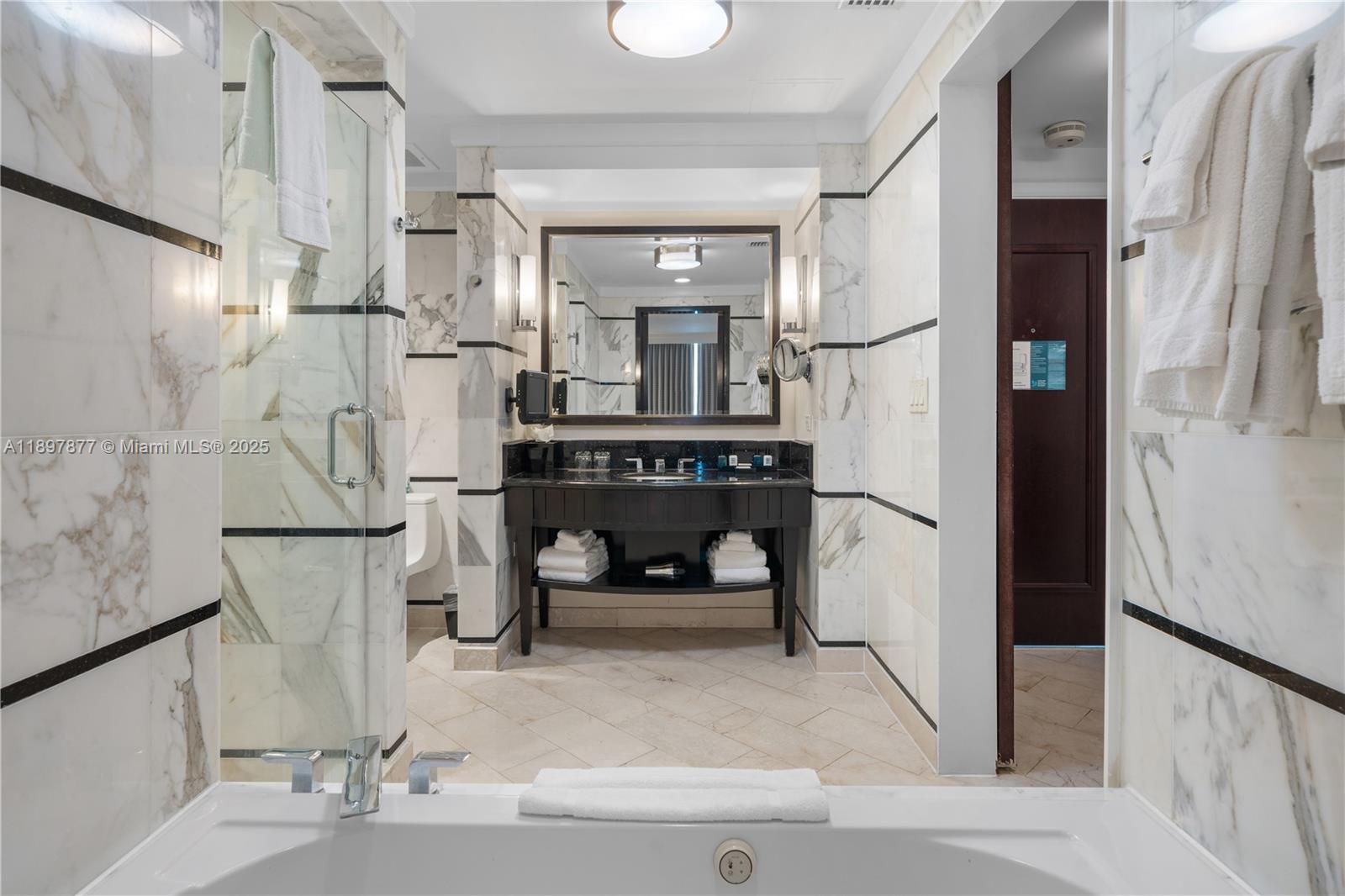 A bathroom features a soaking tub, a glass-enclosed shower, and a dark wood vanity — 4391 Collins Ave # 1403, Miami Beach FL 33140, MIAMI BEACH, FL