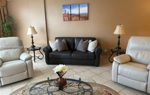 A living room features a dark sofa between two light-colored recliners and a glass coffee table — 3725 S Ocean Dr # 1124, Hollywood FL 33019, HOLLYWOOD, FL
