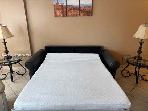 A pull-out sofa bed sits between two side tables with lamps in a room — 3725 S Ocean Dr # 1124, Hollywood FL 33019, HOLLYWOOD, FL
