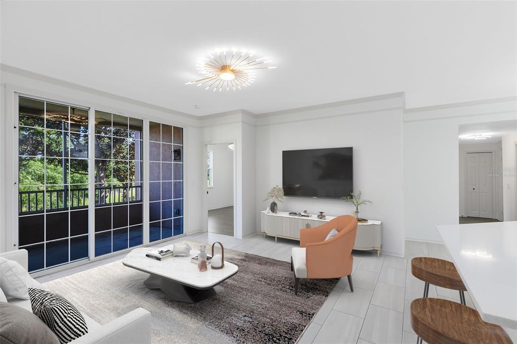 A modern living room features a white sofa, marble coffee table, orange armchair, and balcony — 6685 QUEENS BOROUGH AVENUE UNIT 202, ORLANDO, FL