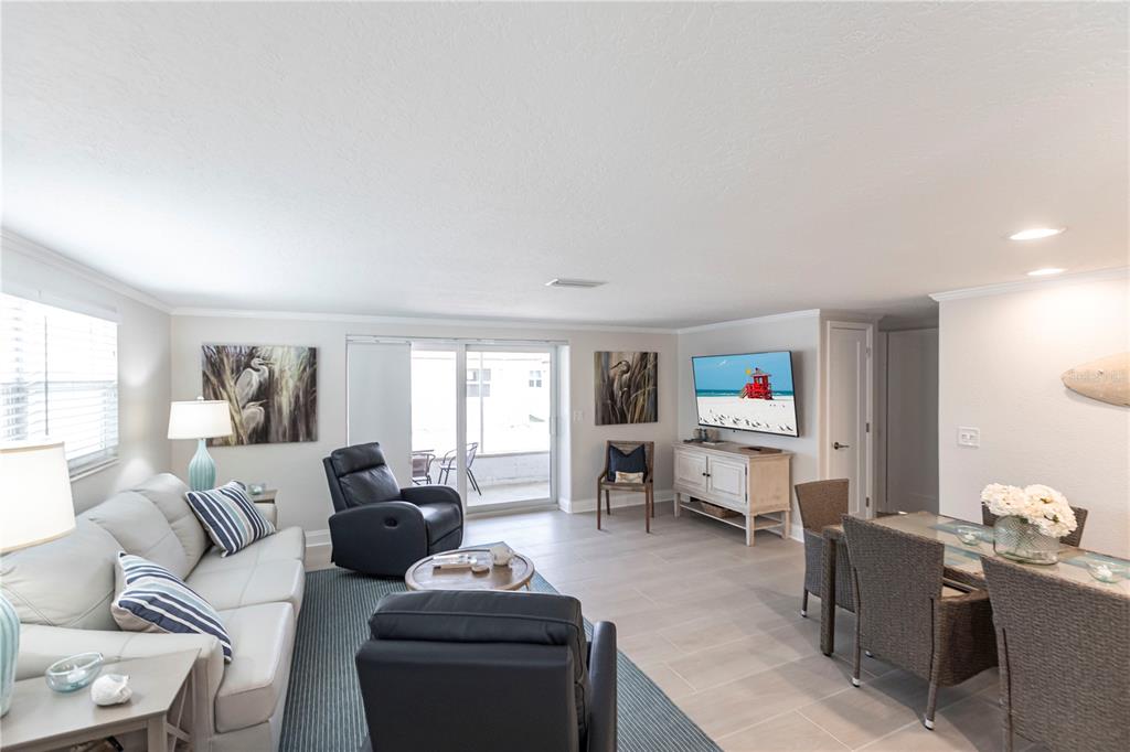 A living and dining area features a light sofa, two recliners, and tile flooring — 6154 MIDNIGHT PASS ROAD UNIT D15, SARASOTA, FL