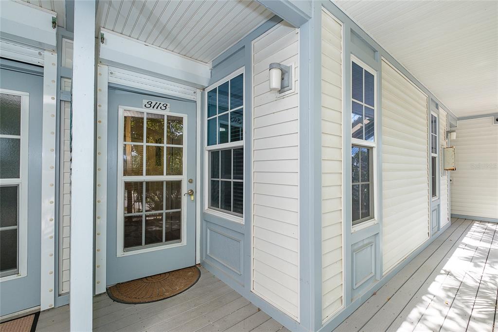 A light blue door with a glass pane and the number 3113 on a porch — 7462 PALM ISLAND DRIVE UNIT 3113, PLACIDA, FL