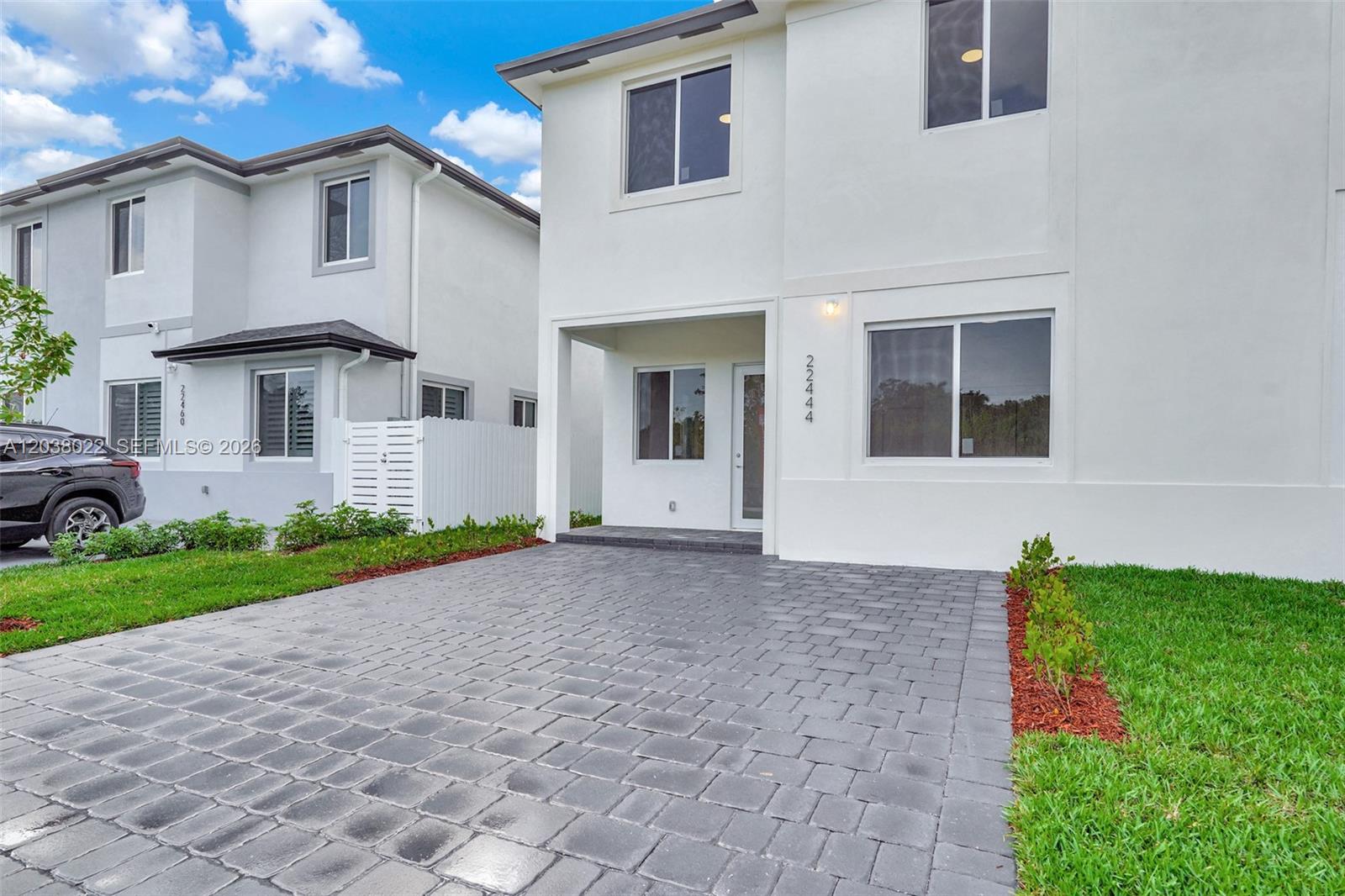 A two-story white house features a paved driveway and a covered front entryway — 22505 SW 125th Ave, Miami FL 33170, MIAMI, FL