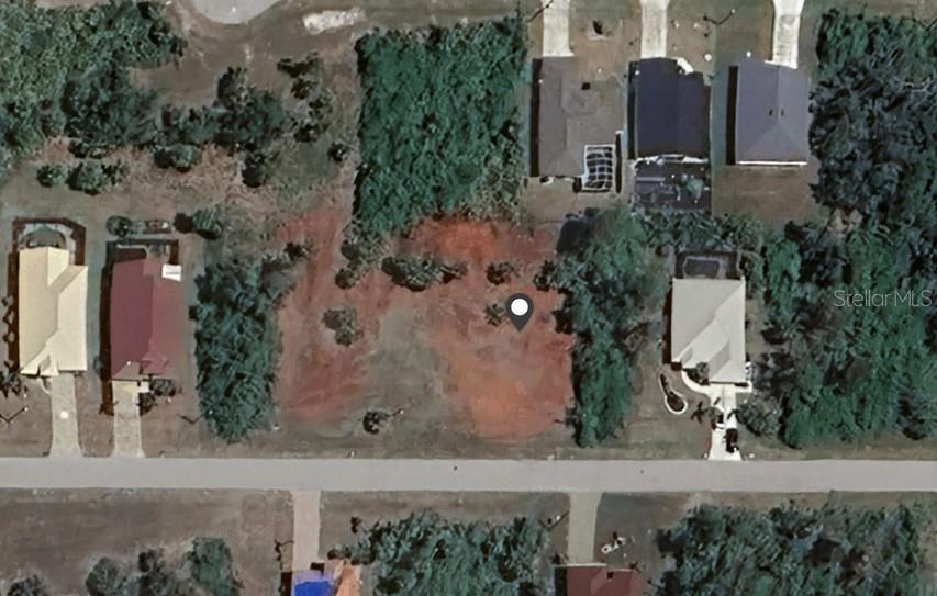 An aerial view shows a vacant, cleared residential lot situated between two existing houses — 384 ALBATROSS ROAD, ROTONDA WEST, FL