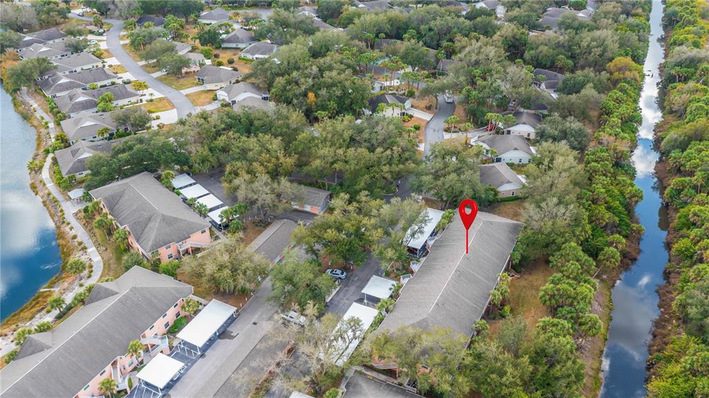 An aerial view shows a multi-unit residential building with a red location pin — 19300 WATER OAK DRIVE UNIT 102, PORT CHARLOTTE, FL