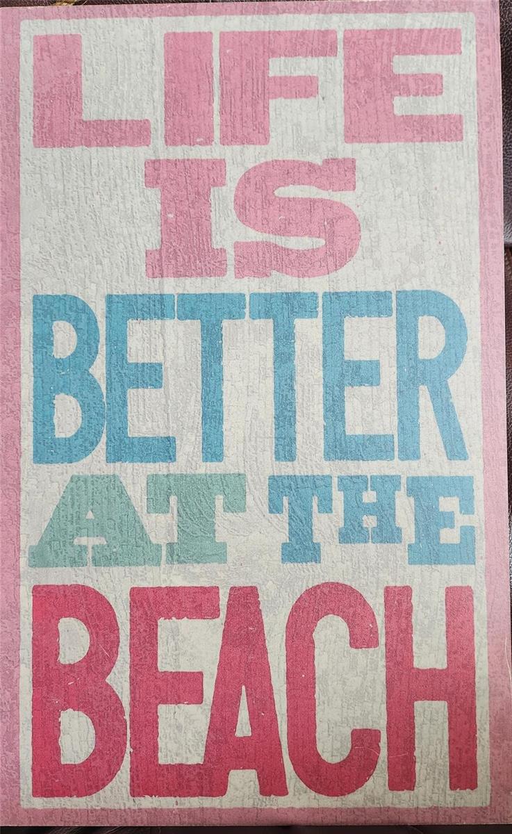 A rectangular wall sign features the text "Life is better at the beach" in colorful lettering — 4111 S Ocean Drive # 2107, Hollywood FL 33019, HOLLYWOOD, FL