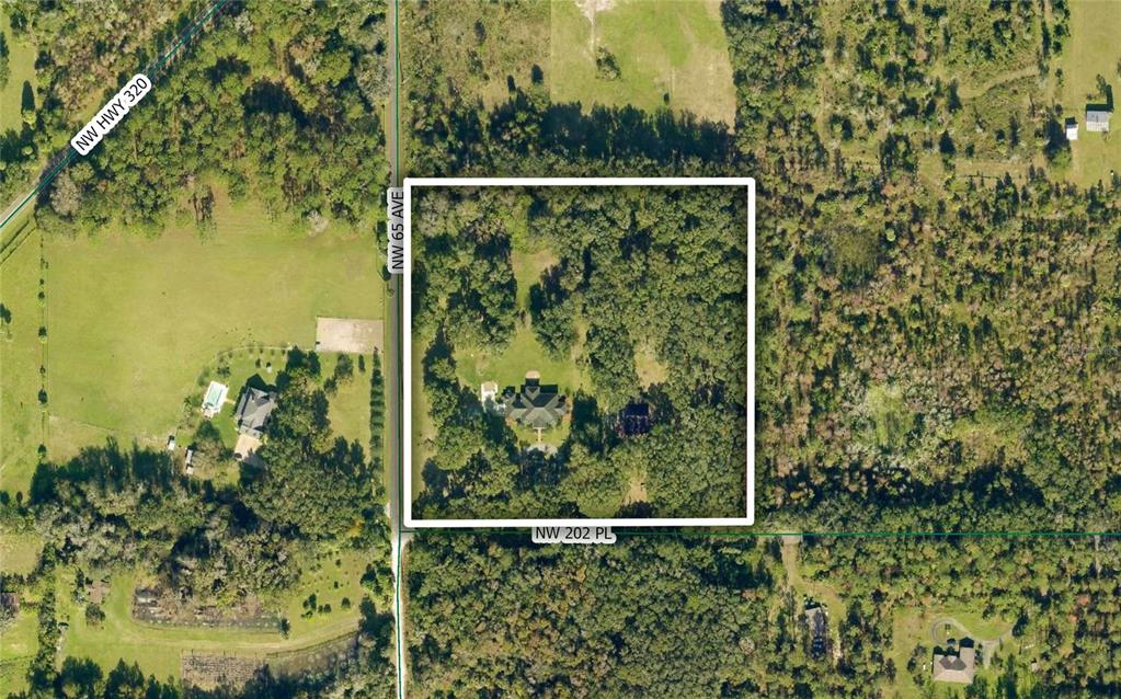 An aerial view shows a house surrounded by trees within a white-bordered property lot — 6425 NW 202ND PLACE, MICANOPY, FL