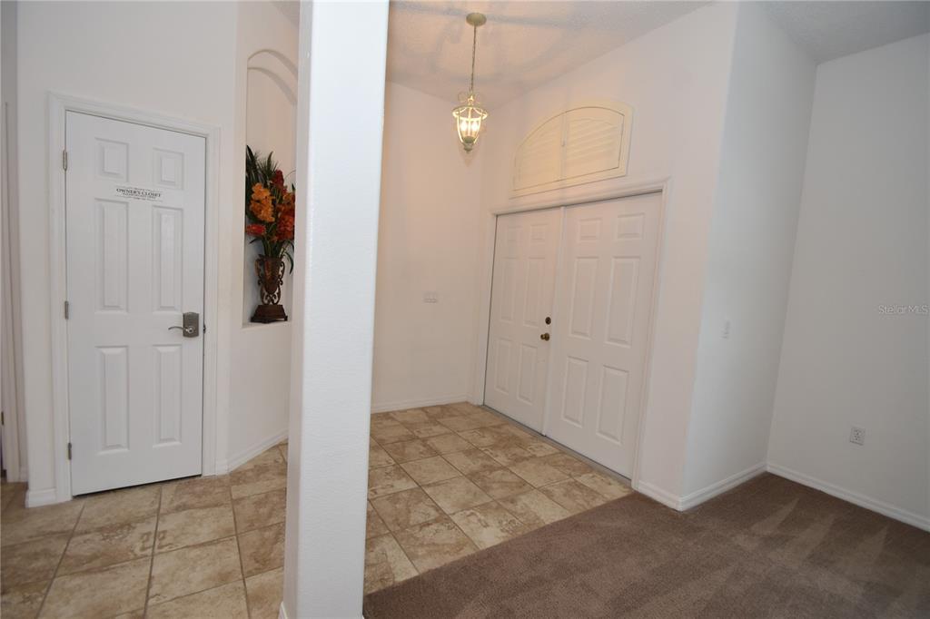 An entryway features tile flooring, a white double door, a chandelier, and a wall niche — 192 PINE GROVE DRIVE, PALM COAST, FL
