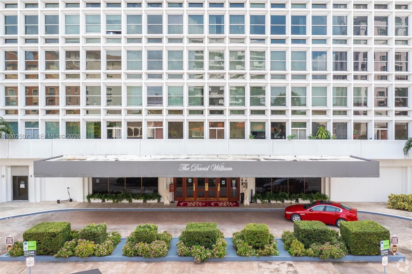 The exterior of The David William building features a white grid facade and a canopy — 700 Biltmore Way # 719, Coral Gables FL 33134, CORAL GABLES, FL