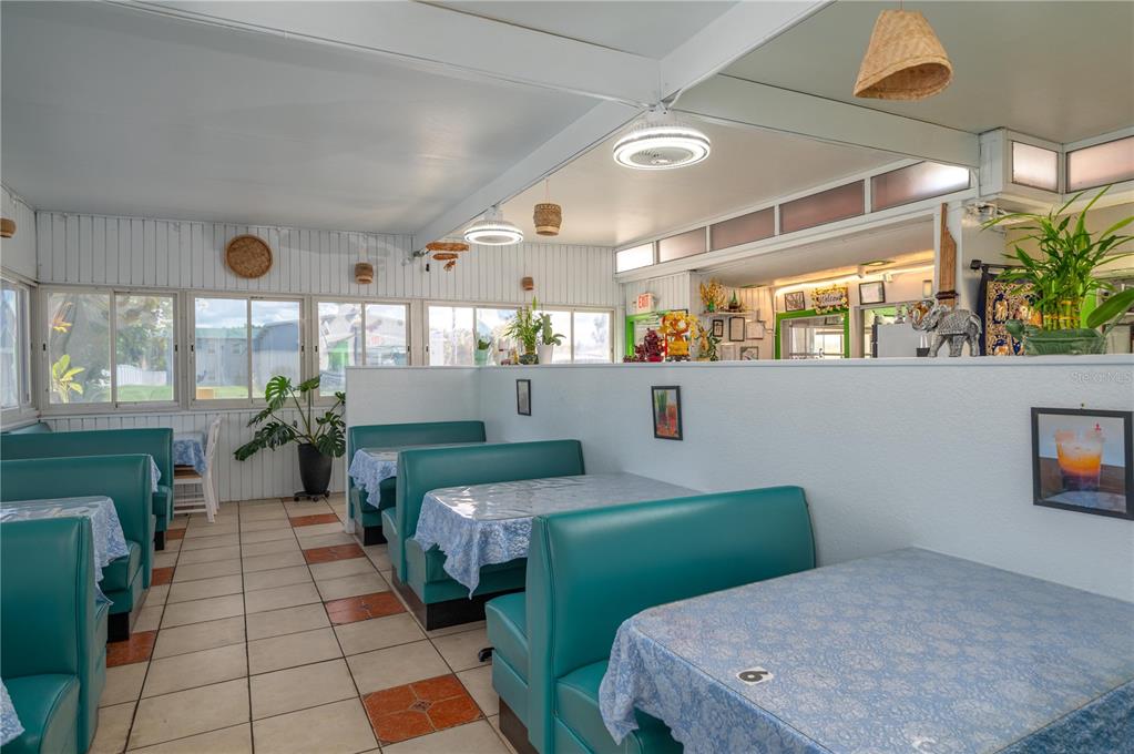 A restaurant dining area features teal booths, light blue tablecloths, and tiled flooring — 114 W CENTRAL AVENUE, LAKE WALES, FL
