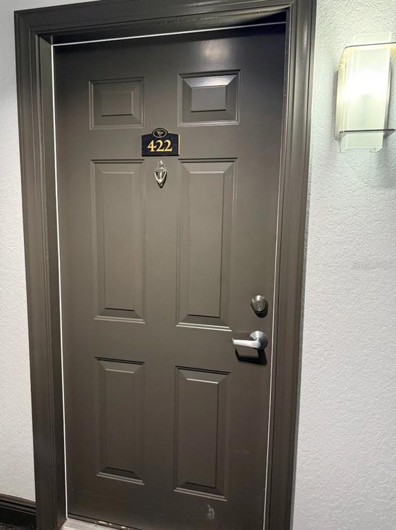 A dark gray apartment door with the number 422 and a wall-mounted light fixture — 700 S HARBOUR ISLAND BOULEVARD UNIT 422, TAMPA, FL