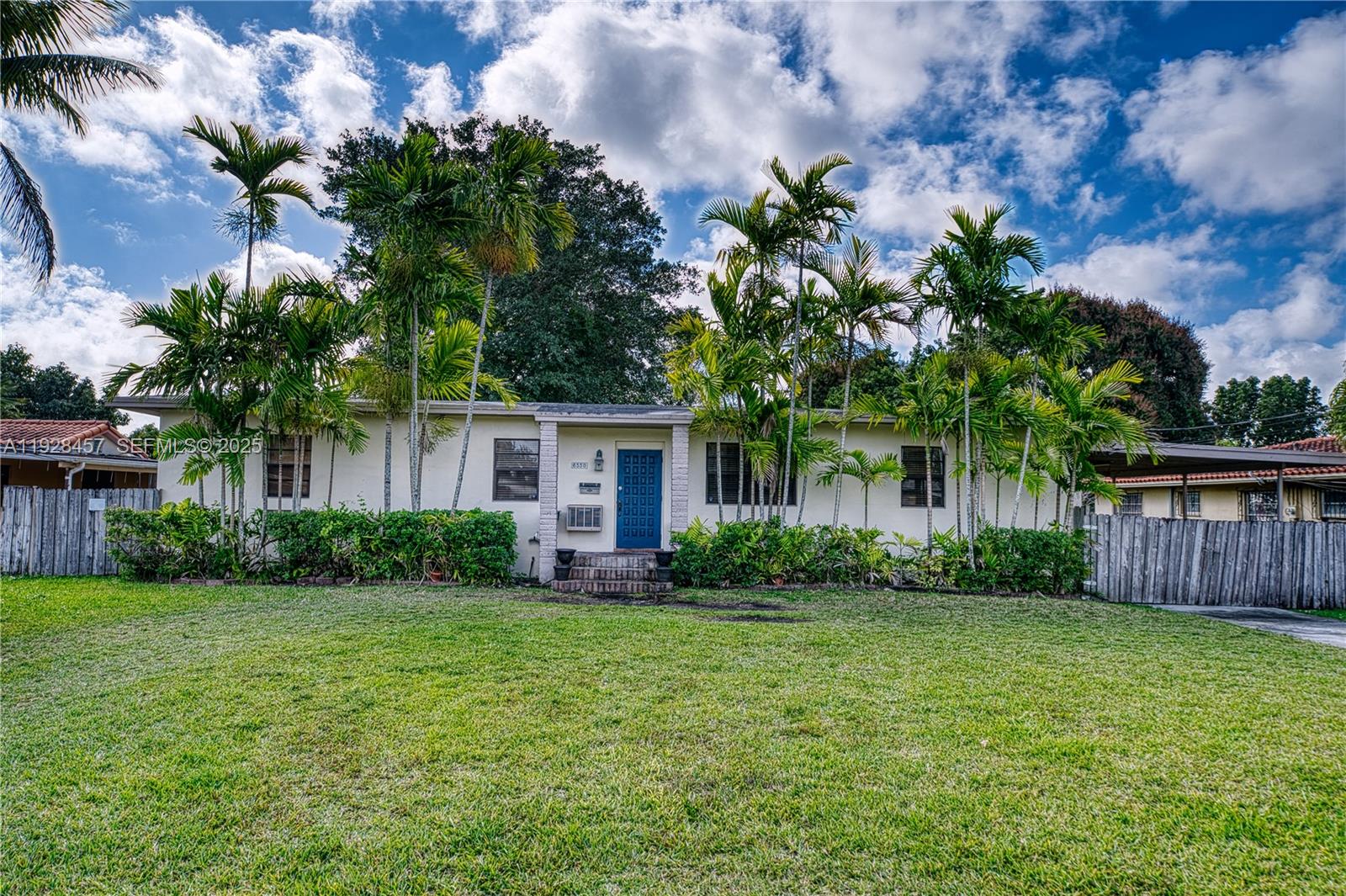 A single-story house with a blue front door is surrounded by palm trees and grass — 6550 SW 27th St, Miami FL 33155, MIAMI, FL