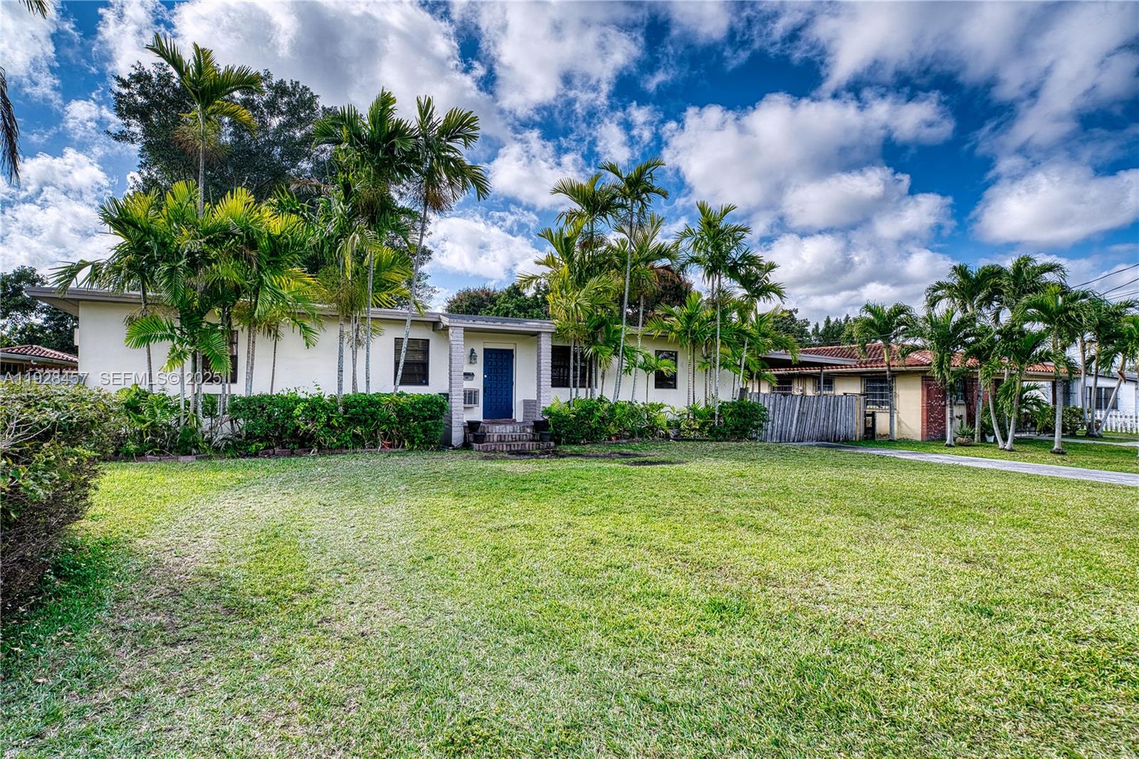 A single-story house with a blue front door, palm trees, and a large front lawn — 6550 SW 27th St, Miami FL 33155, MIAMI, FL