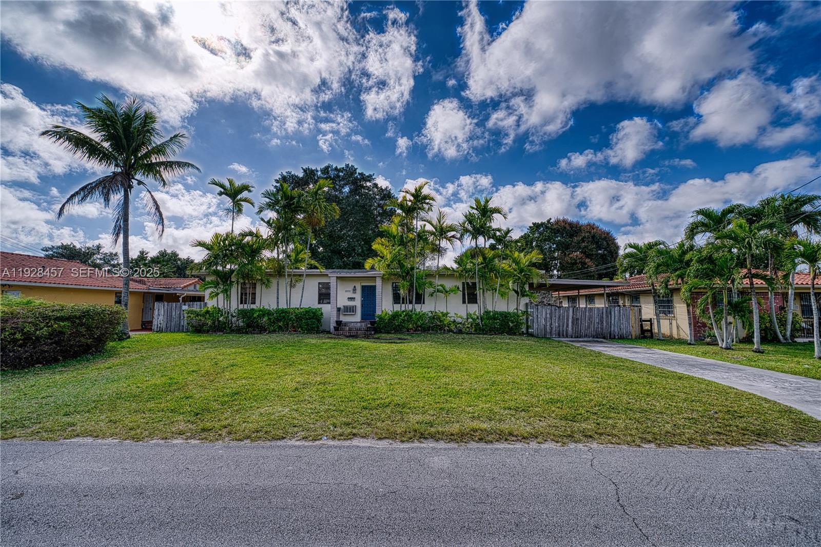 A single-story house with a lawn, palm trees, and a driveway under a cloudy sky — 6550 SW 27th St, Miami FL 33155, MIAMI, FL