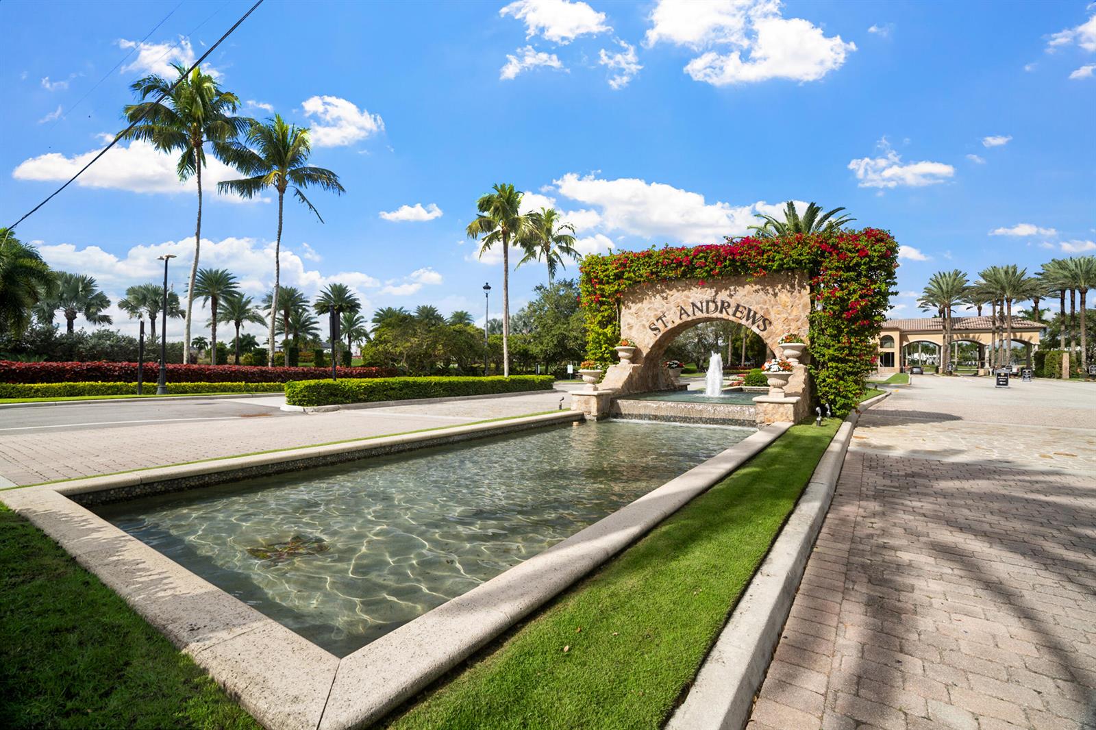 A stone entrance arch with a fountain and landscaping marks the St. Andrews community — 7946 Shelby Circle, Boca Raton FL 33496, BOCA RATON, FL