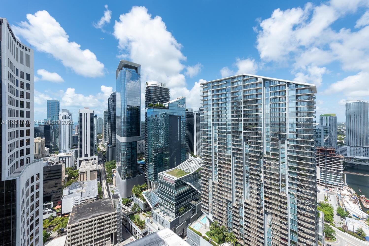 An elevated view of a dense urban skyline featuring multiple modern high-rise glass skyscrapers — 55 SE 6th St # 4308, Miami FL 33131, MIAMI, FL