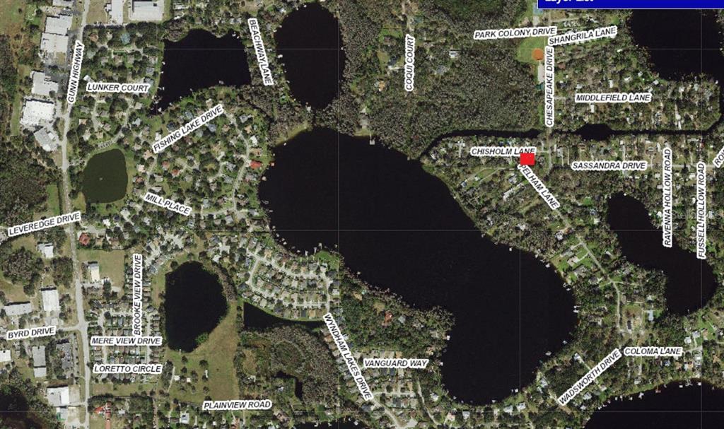 This is an aerial map showing residential streets surrounding a large lake — 14328 CHISHOLM LANE, ODESSA, FL