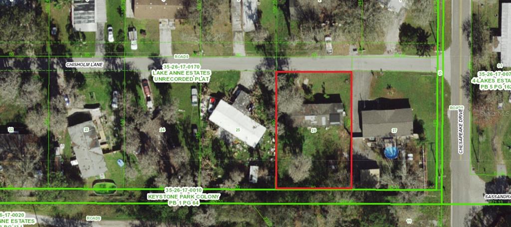 This aerial map shows a residential lot highlighted in red among neighboring properties and streets — 14328 CHISHOLM LANE, ODESSA, FL