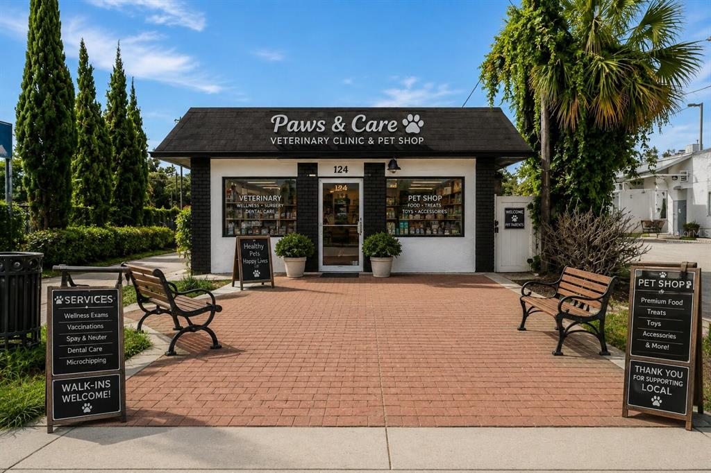 The exterior of a brick veterinary clinic and pet shop features two benches and signage — 124 N APOPKA AVENUE, INVERNESS, FL