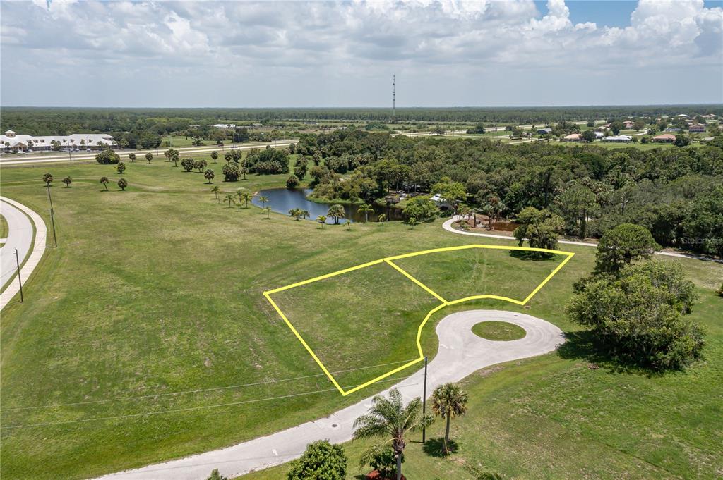 An aerial view shows two adjacent vacant lots outlined in yellow near a cul-de-sac — 16494 TOGAS WAY, PUNTA GORDA, FL