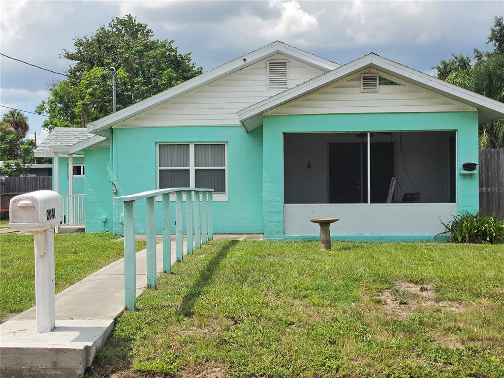 A teal, single-story house features a screened-in front porch and a concrete walkway with railings — 2041 JEWELL AVENUE, WINTER PARK, FL