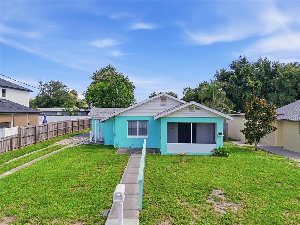 A turquoise single-story house with a screened front porch and a concrete walkway — 2041 JEWELL AVENUE, WINTER PARK, FL
