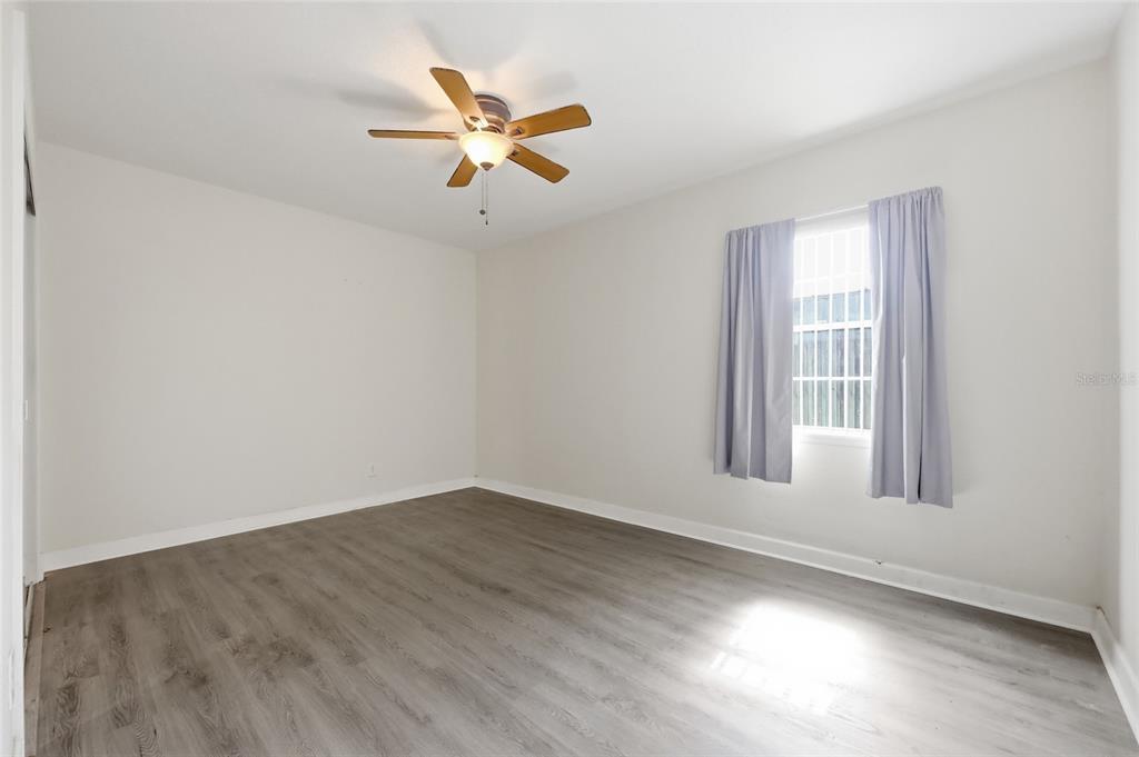 A living room features tile flooring, a double front door, and two beige sofas — 2041 JEWELL AVENUE, WINTER PARK, FL