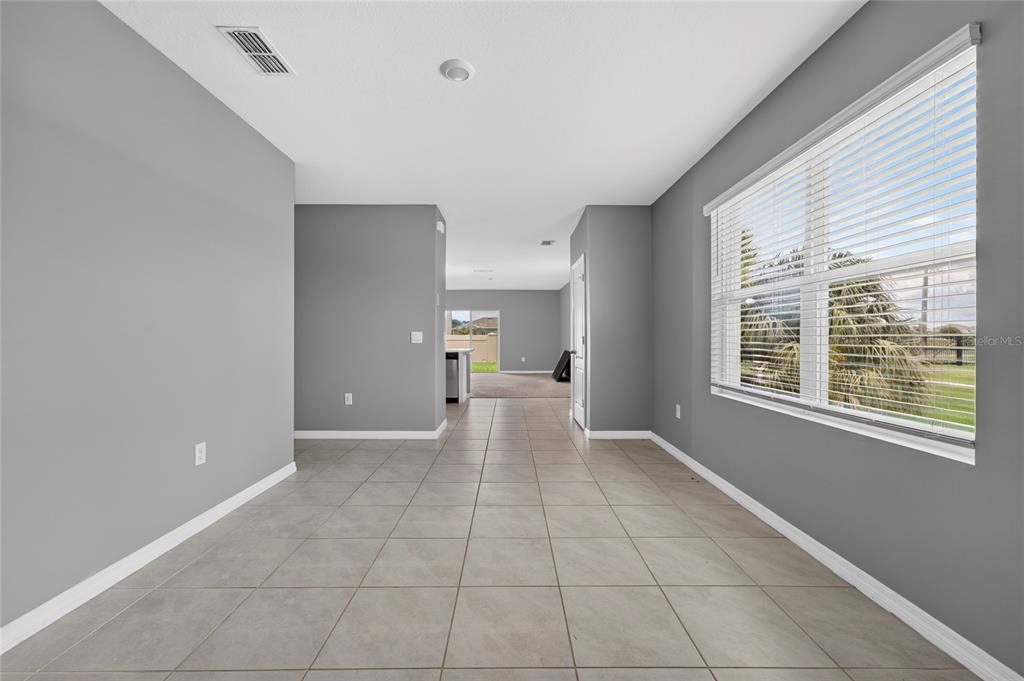 A room with gray walls, tiled flooring, two white doors, and recessed ceiling lighting — 3894 SILVERSTREAM TER, SANFORD, FL