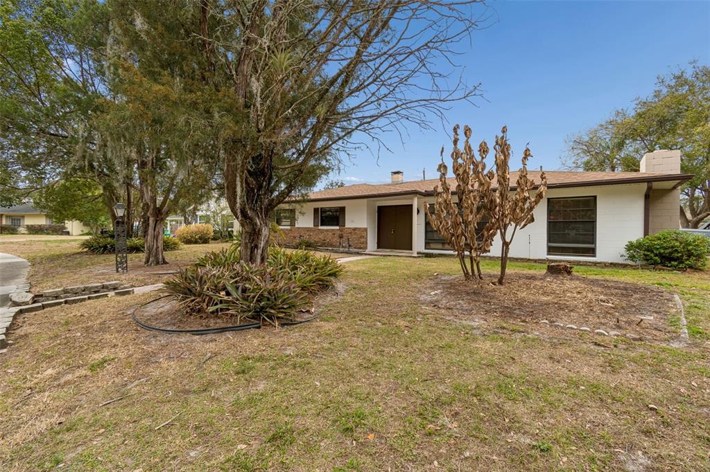 A single-story house with a white exterior, brick accents, and a front walkway — 2708 LION HEART ROAD, WINTER PARK, FL