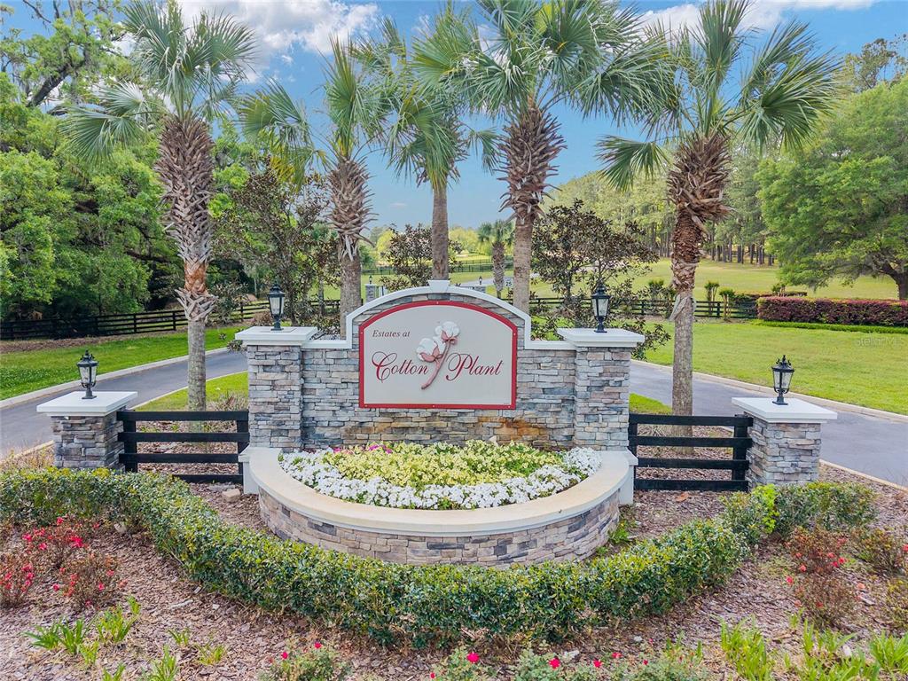 A stone entrance sign for Estates at Cotton Plant features palm trees and white flowers — TBD SW 144 COURT ROAD, OCALA, FL