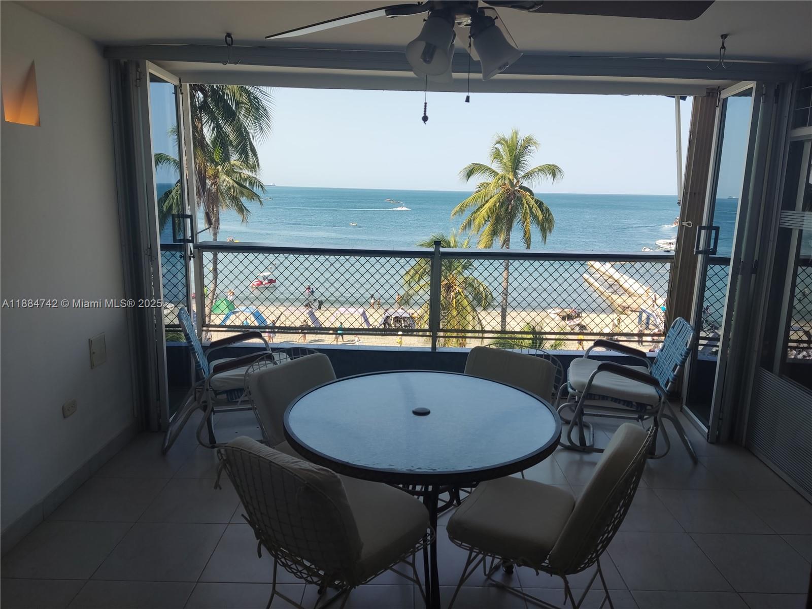 A balcony with a dining set overlooks a beach and the ocean — Carrera 1a # 5-06, SA 130001, SA