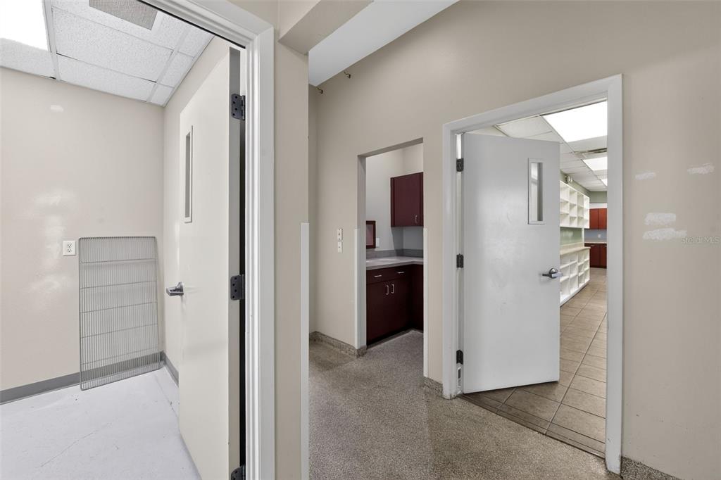An interior view showing a hallway leading to a small kitchen area and adjacent rooms — 2555 PINELLAS POINT DRIVE S, ST PETERSBURG, FL