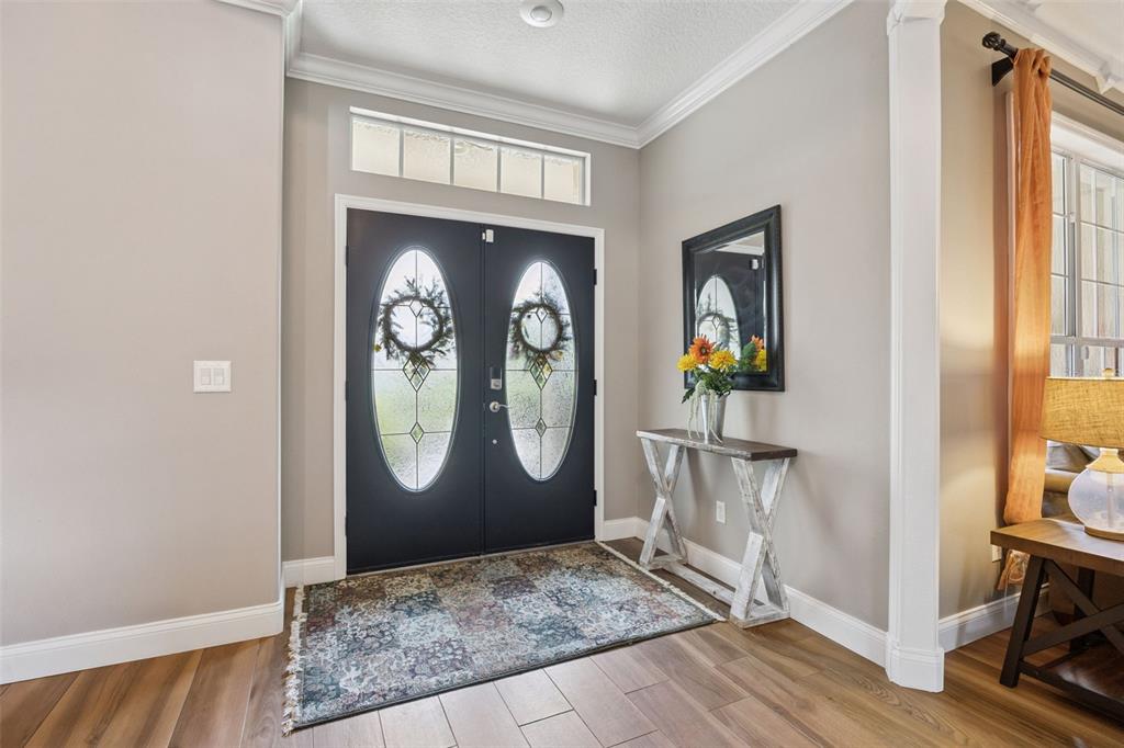 A covered patio features a tiled floor, a wicker loveseat, and a glass-topped coffee table — 1267 OAKFORD PLACE, OVIEDO, FL