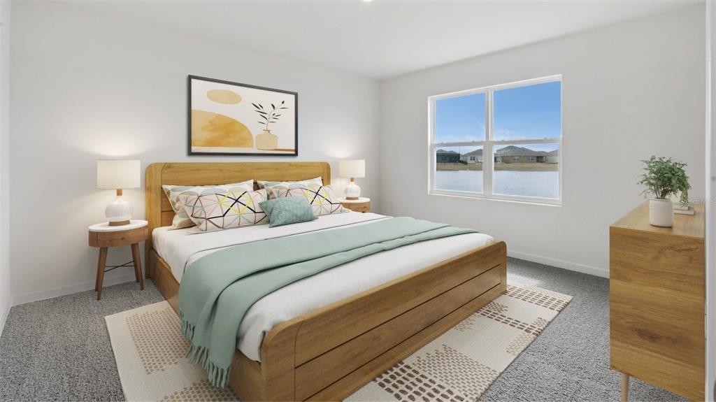A bedroom features a wooden bed frame, two nightstands, and a window overlooking a lake — 1901 DEEP LAKE CIRCLE, NEW SMYRNA BEACH, FL