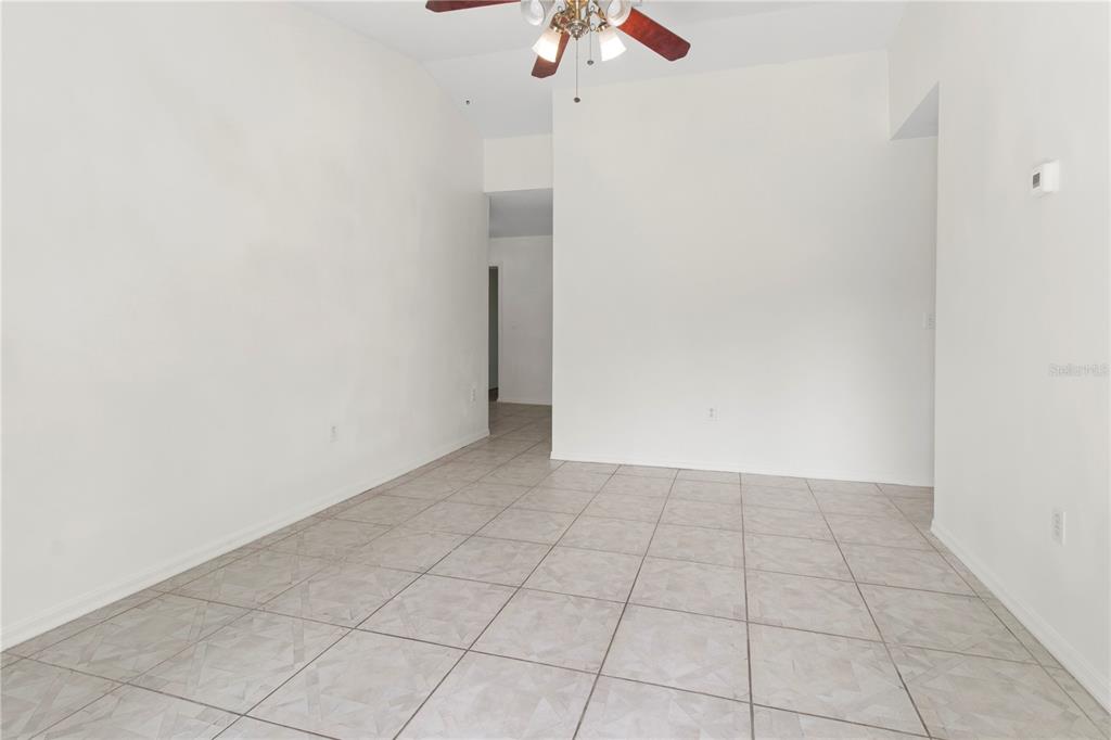 An empty room with white walls, tiled flooring, and a ceiling fan — 4715 4TH AVENUE E, PALMETTO, FL