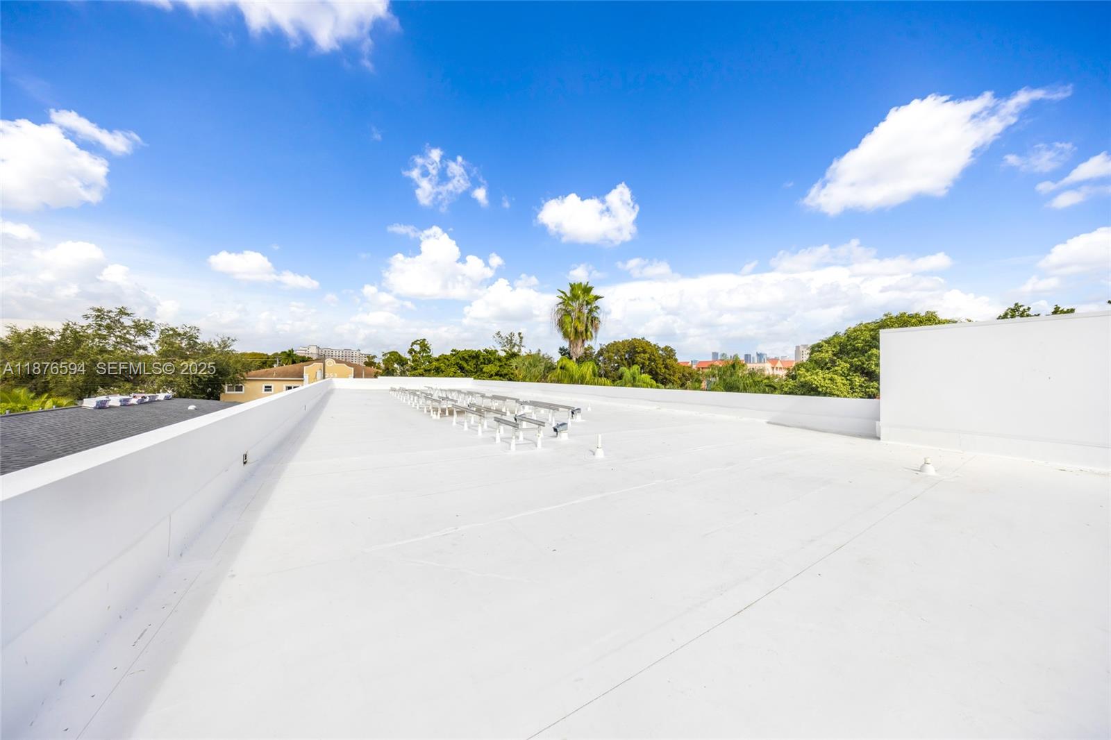 A flat, white rooftop features a series of metal mounting brackets under a blue sky — 1254 SW 2nd St, Miami FL 33135, MIAMI, FL