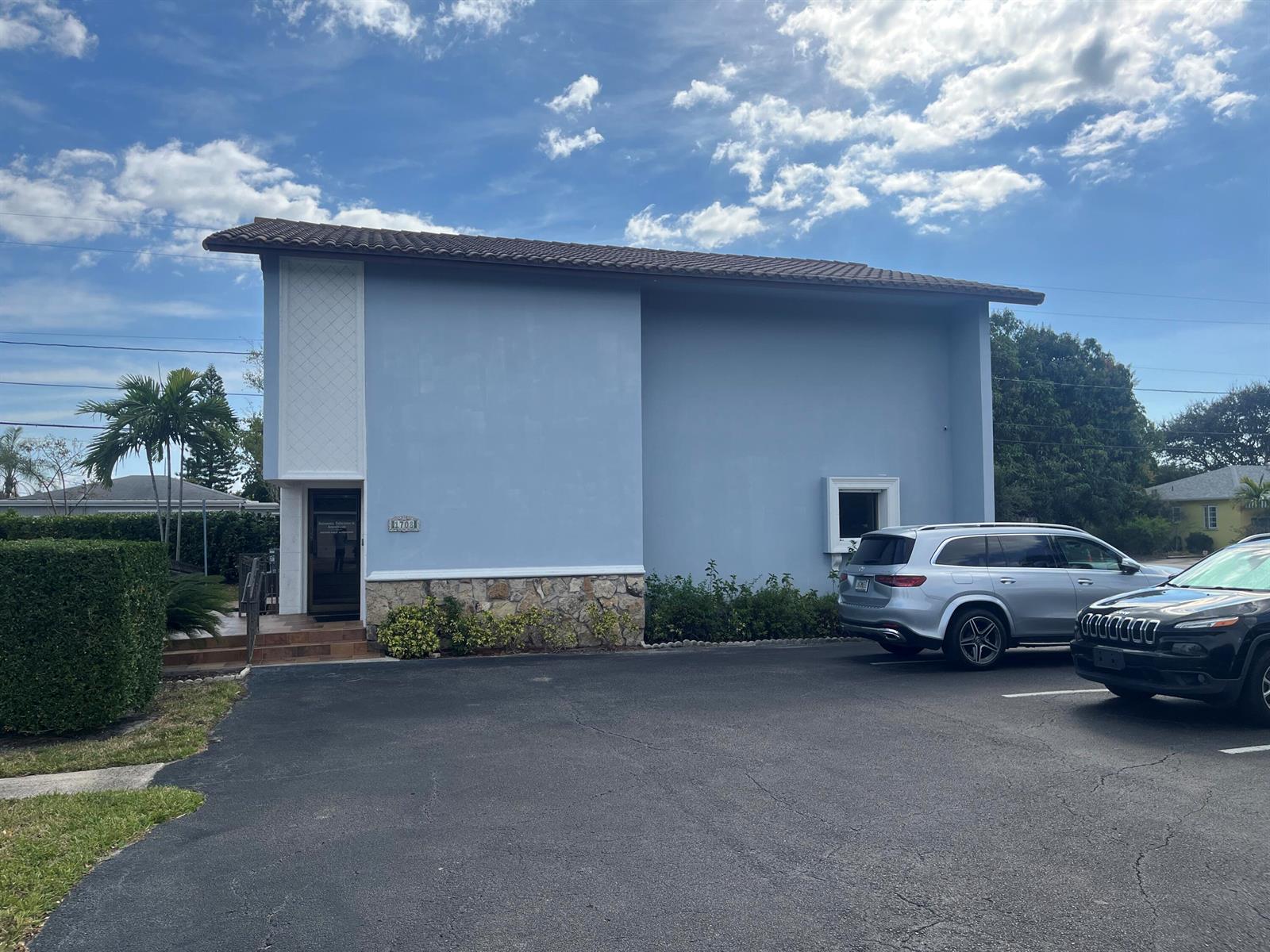 A light blue two-story commercial building with a stone base and a parking lot — 1708 N Federal Highway, FL 33460, FL