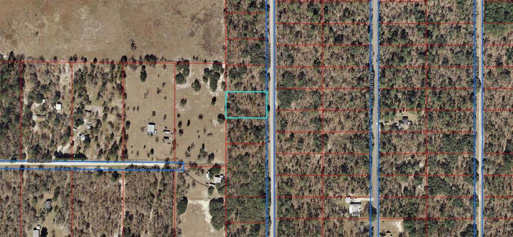 This is an aerial map showing a vacant rectangular lot highlighted in blue — LOT 10 SE 125TH COURT, DUNNELLON, FL