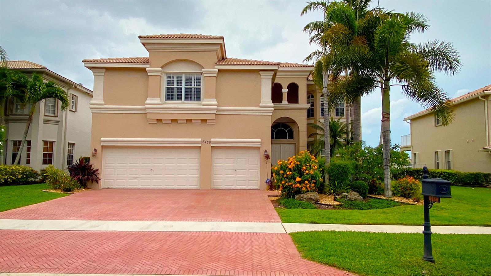 A two-story beige house with a red brick driveway and a two-car garage — 6489 Marbletree Lane, Lake Worth FL 33467, LAKE WORTH, FL
