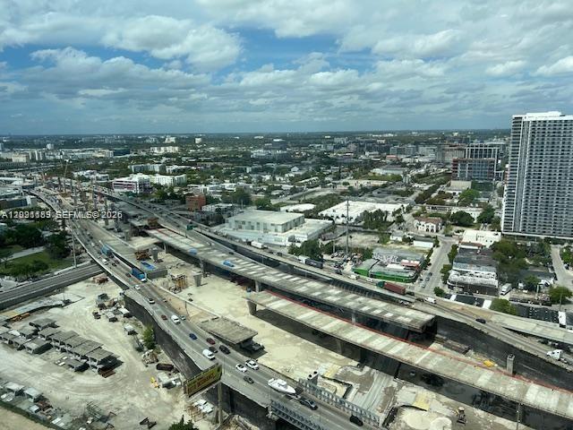 An aerial view shows a highway construction site next to a tall residential building — 20 NE 11 St # 3611, Miami FL 33132, MIAMI, FL