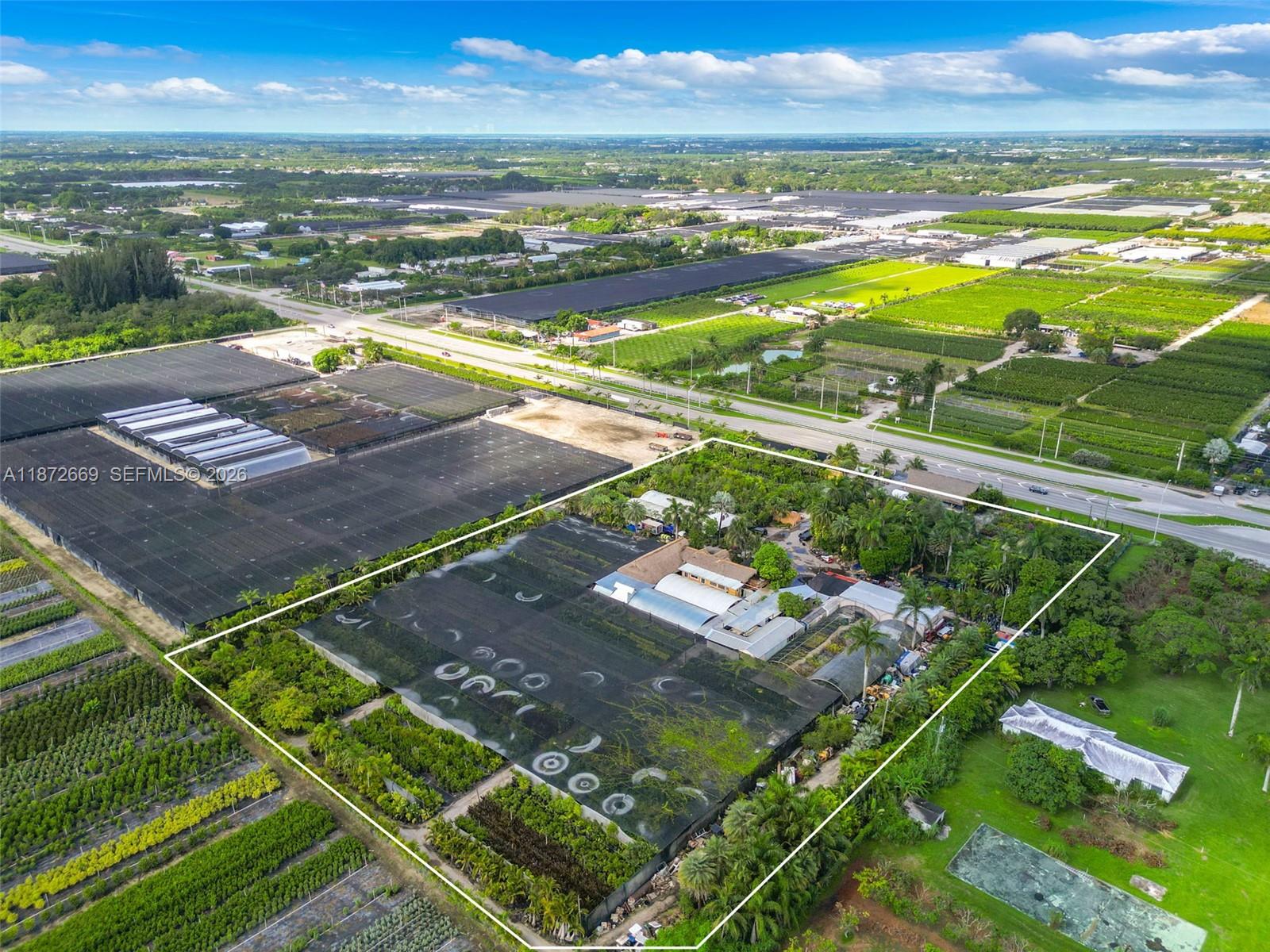 An aerial view shows a property with a large nursery structure and surrounding agricultural land — 20425 SW 177th av, Miami FL 33187, MIAMI, FL
